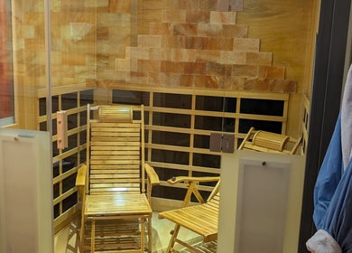 Relaxing sauna with wooden chairs at J. Madison Spa, Kingston, PA, US, offering serene wellness experiences.