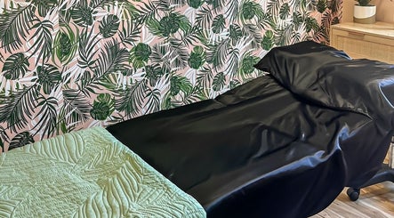 Cozy spa bed with tropical wallpaper at Rosy Cheeks Beauty Studio, Biddeford, Maine, US.