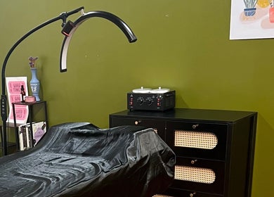 Comfortable treatment space at Rosy Cheeks Beauty Studio, Biddeford, Maine, US, with a stylish green backdrop.