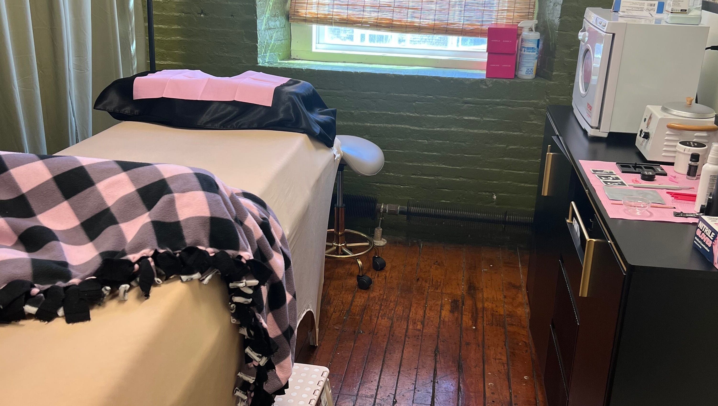 Comfortable treatment room at Rosy Cheeks Beauty Studio in Biddeford, Maine, US with plush blankets and equipment.