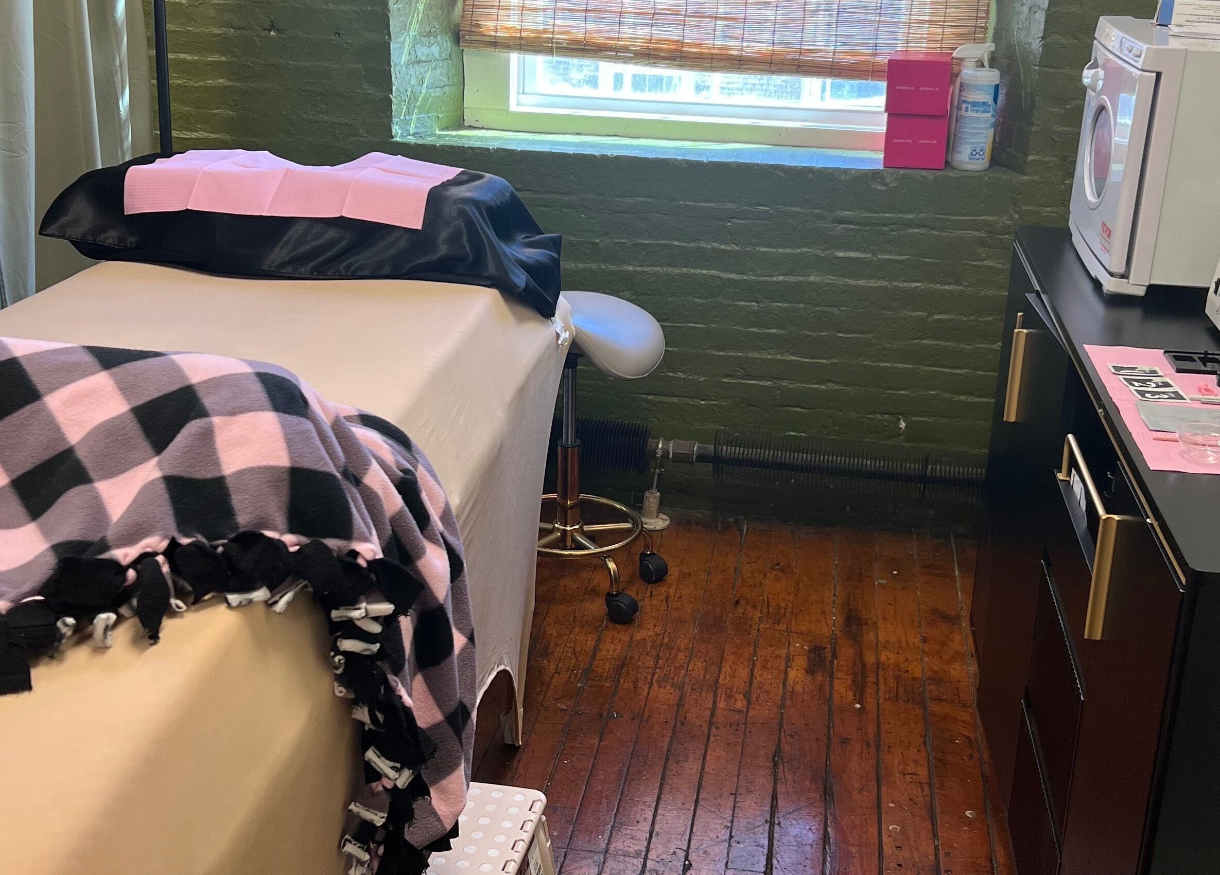 Comfortable treatment room at Rosy Cheeks Beauty Studio in Biddeford, Maine, US with plush blankets and equipment.
