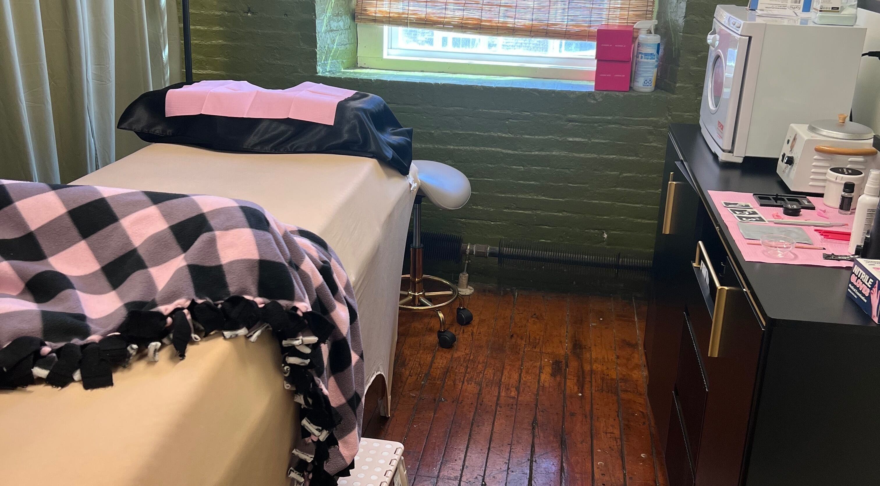 Comfortable treatment room at Rosy Cheeks Beauty Studio in Biddeford, Maine, US with plush blankets and equipment.