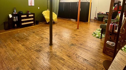 Spacious interior of Rosy Cheeks Beauty Studio with wooden floors in Biddeford, Maine, US.