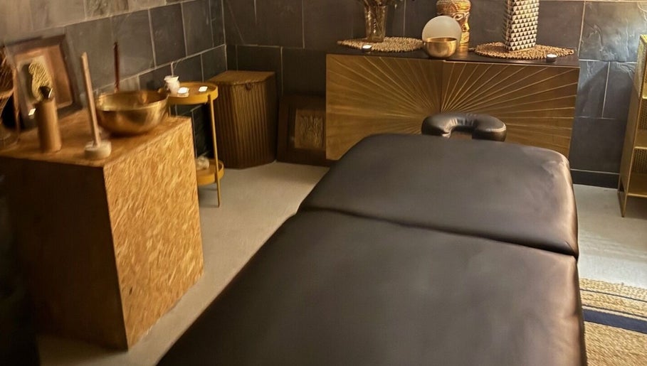 Serenity Sound Healing relaxation room in London, England, GB with a massage table and tranquil decor.