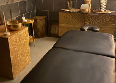 Serenity Sound Healing relaxation room in London, England, GB with a massage table and tranquil decor.