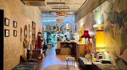 Cozy interior of Serenity Sound Healing, London, England, GB, with rustic decor and vibrant wall art.