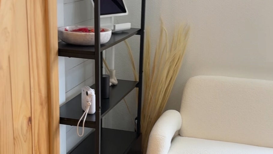 Modern shelf decor in Haus of BossBunnii, Orlando, Florida, US, featuring a sleek chair and minimal accents.