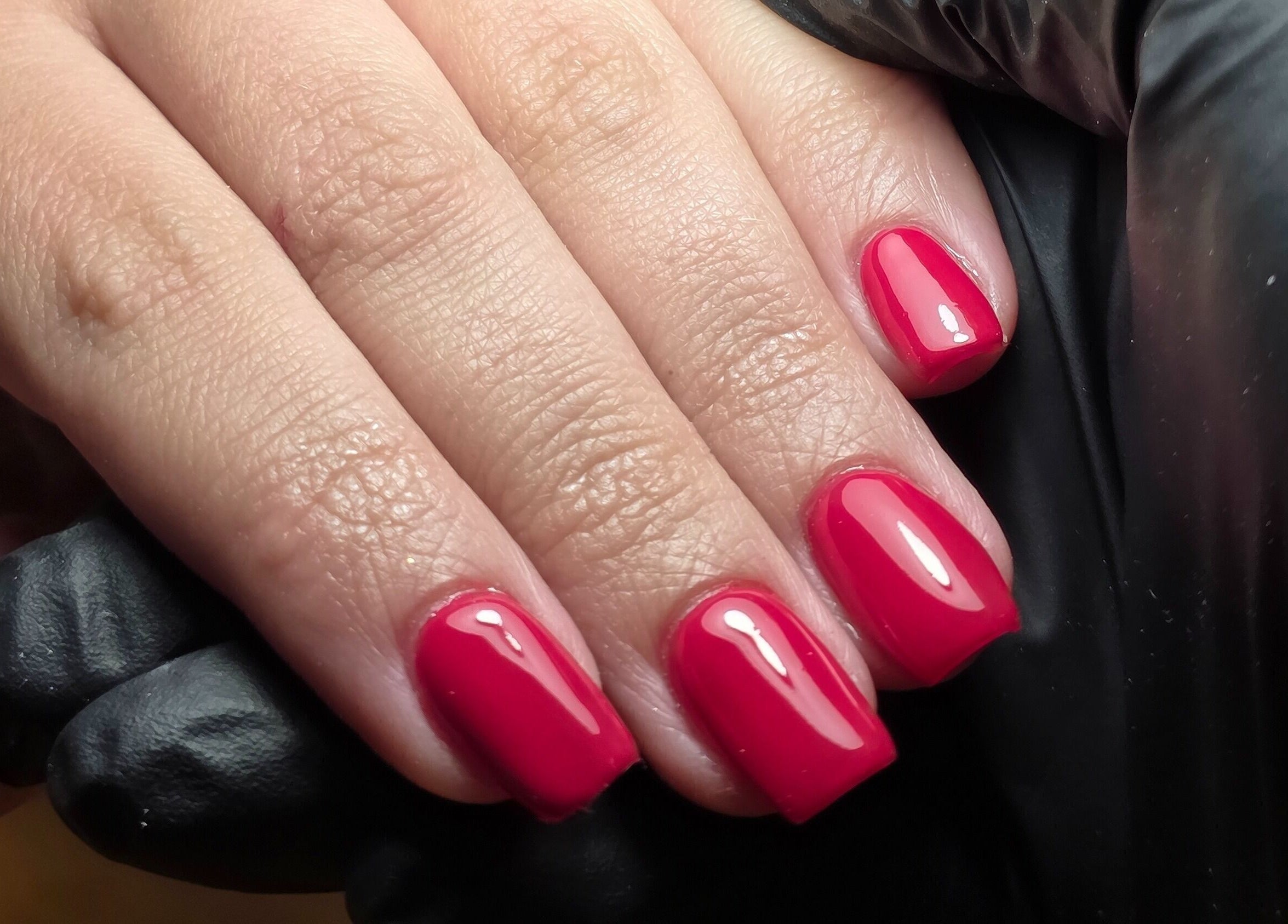 Perfectly manicured glossy red nails at MANI.FEST Nails, Barry, Wales, GB.