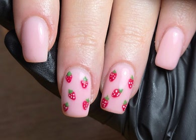 Cute strawberry nail art by MANI.FEST Nails in Barry, Wales, GB showcasing pink nails with red designs.