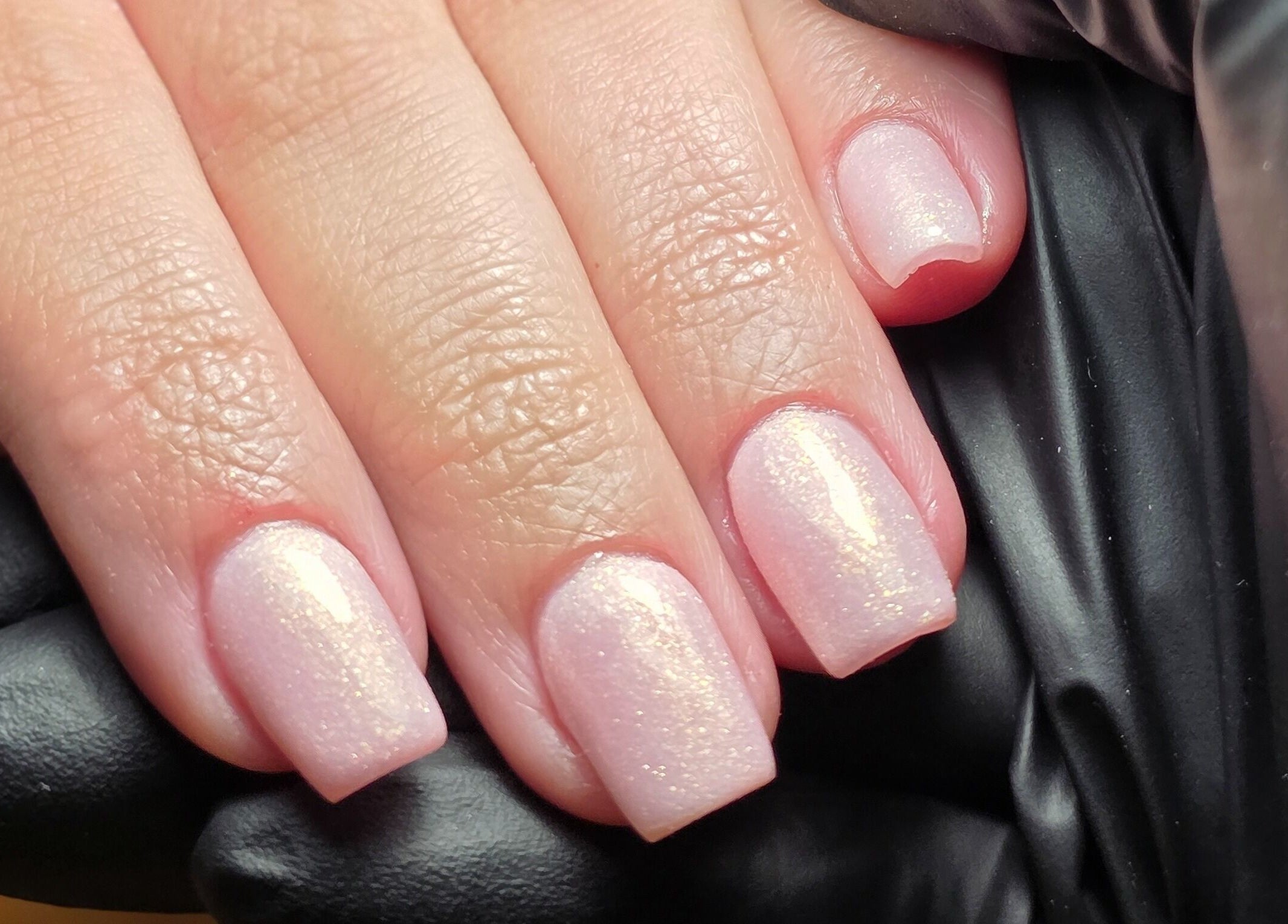 Sparkling nail art at MANI.FEST Nails, Barry, Wales, GB showcasing elegant, shimmering finish.