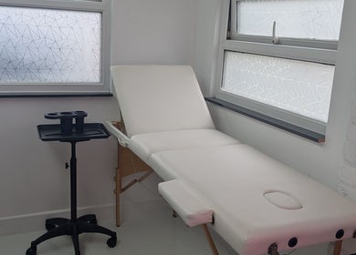 A tranquil therapy room at Love That, Cemaes Bay, Wales, GB featuring a comfortable treatment bed.