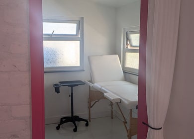 Calm treatment room at Love That in Cemaes Bay, Wales, GB with massage bed and soft lighting.