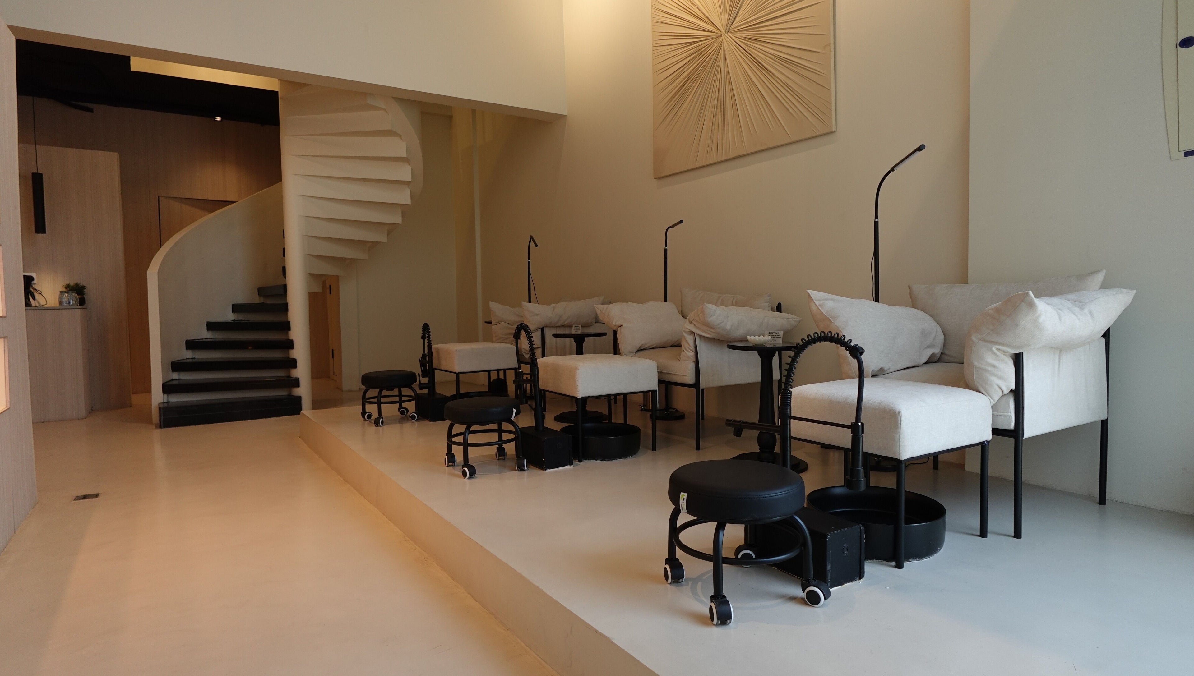 Chic nail care setup at Noura Fahed Salon, Dammam, Eastern Province, SA, featuring modern seating and decor.