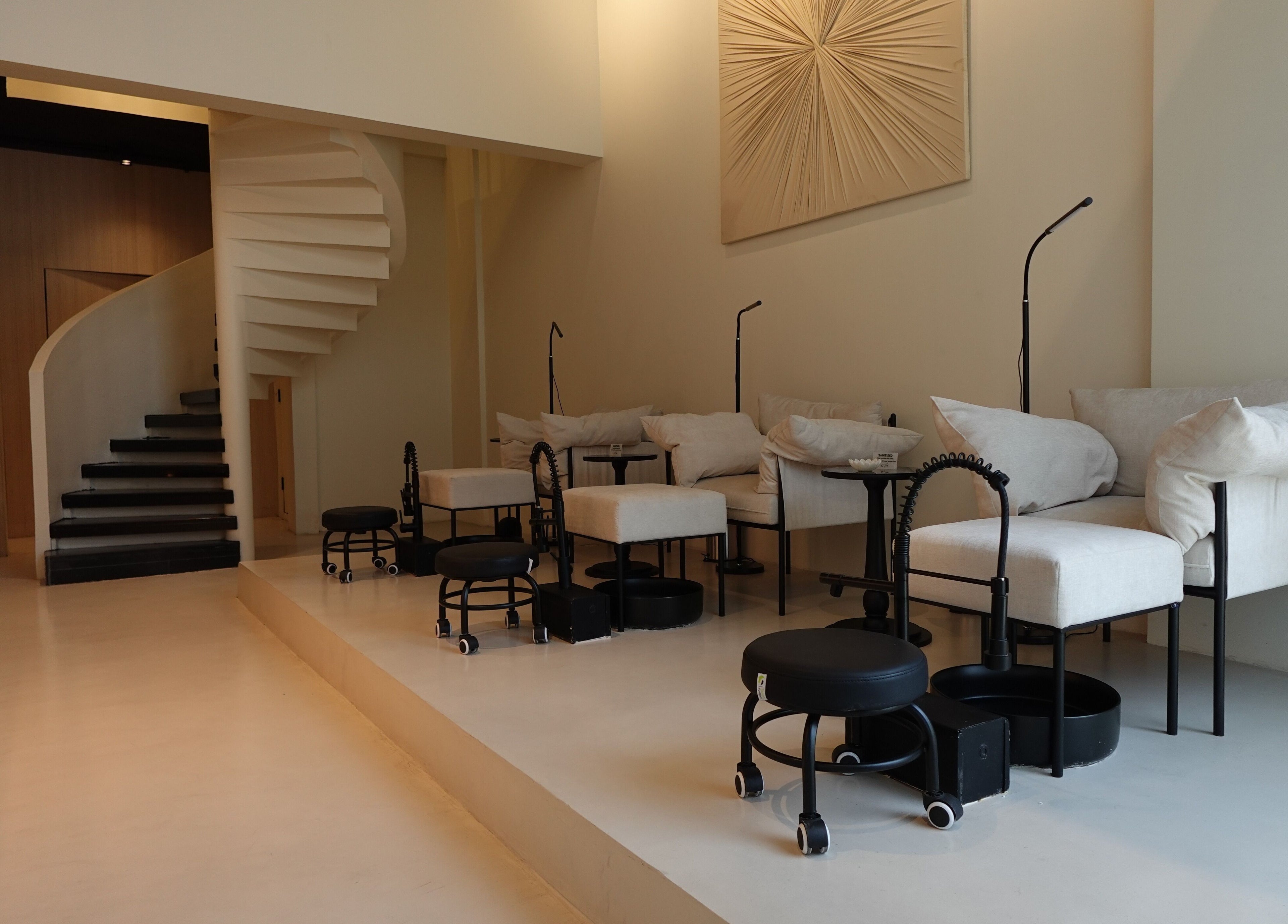 Chic nail care setup at Noura Fahed Salon, Dammam, Eastern Province, SA, featuring modern seating and decor.