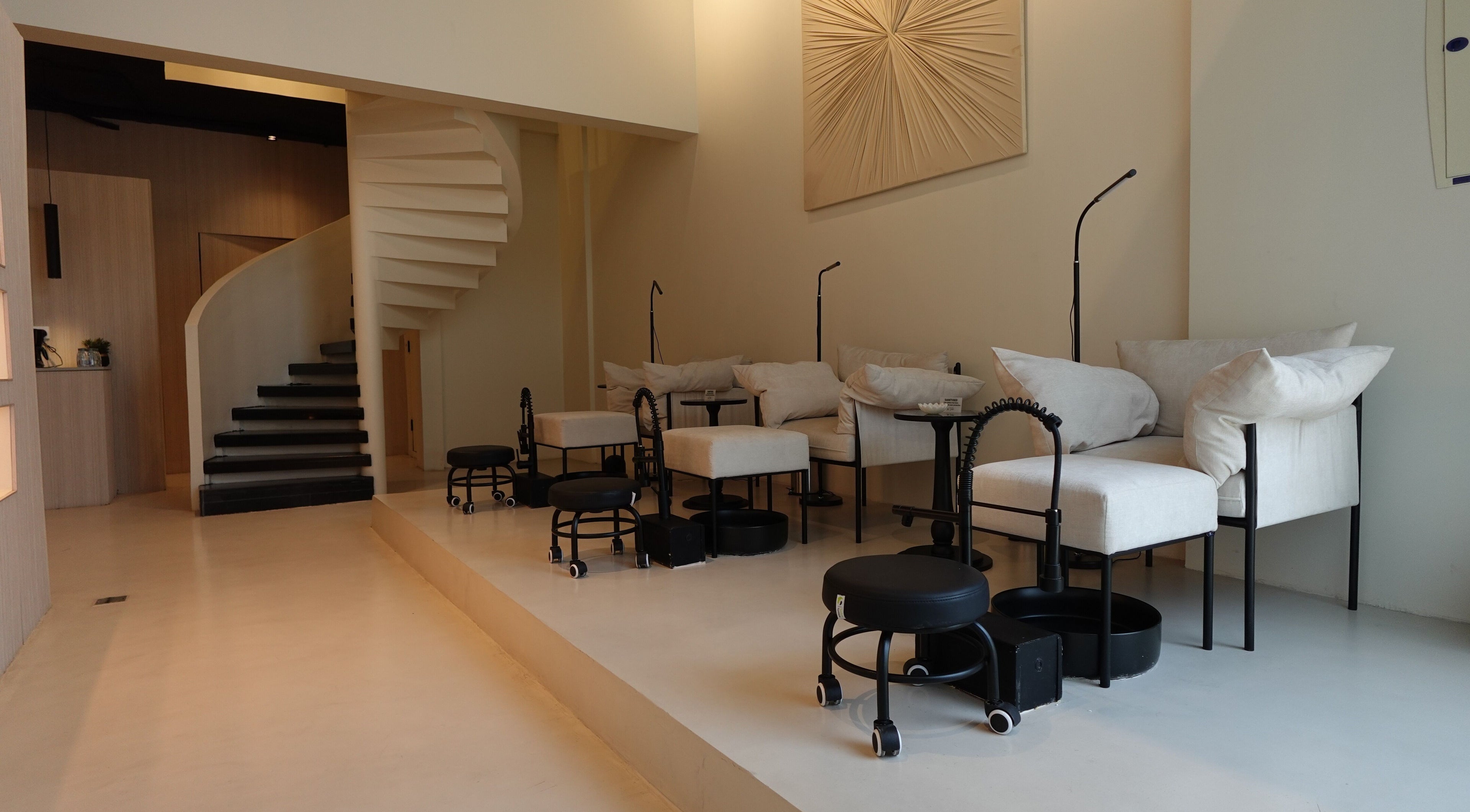 Chic nail care setup at Noura Fahed Salon, Dammam, Eastern Province, SA, featuring modern seating and decor.