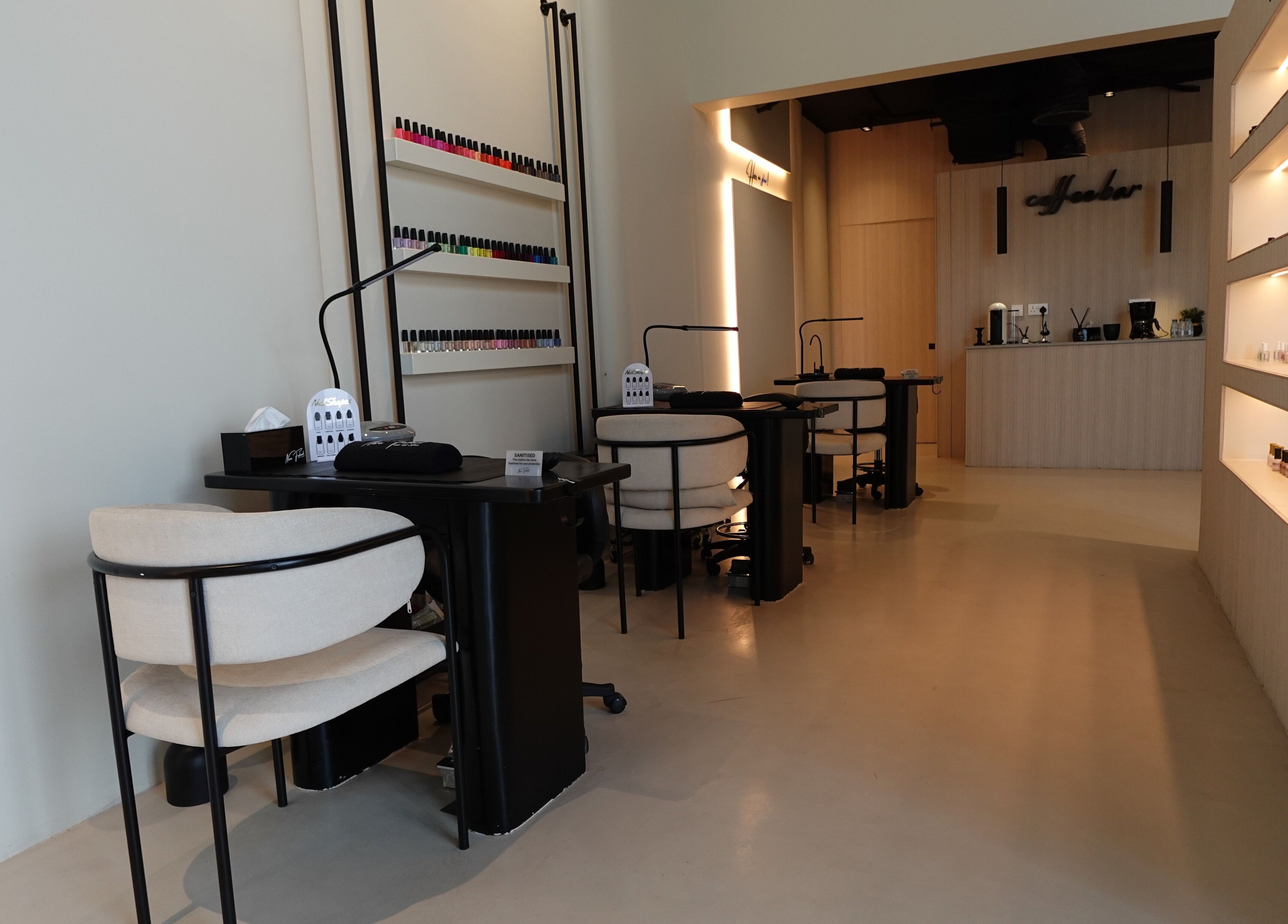 Modern nail salon interior at Noura Fahed Salon, Dammam, Eastern Province, SA, featuring stylish seating.