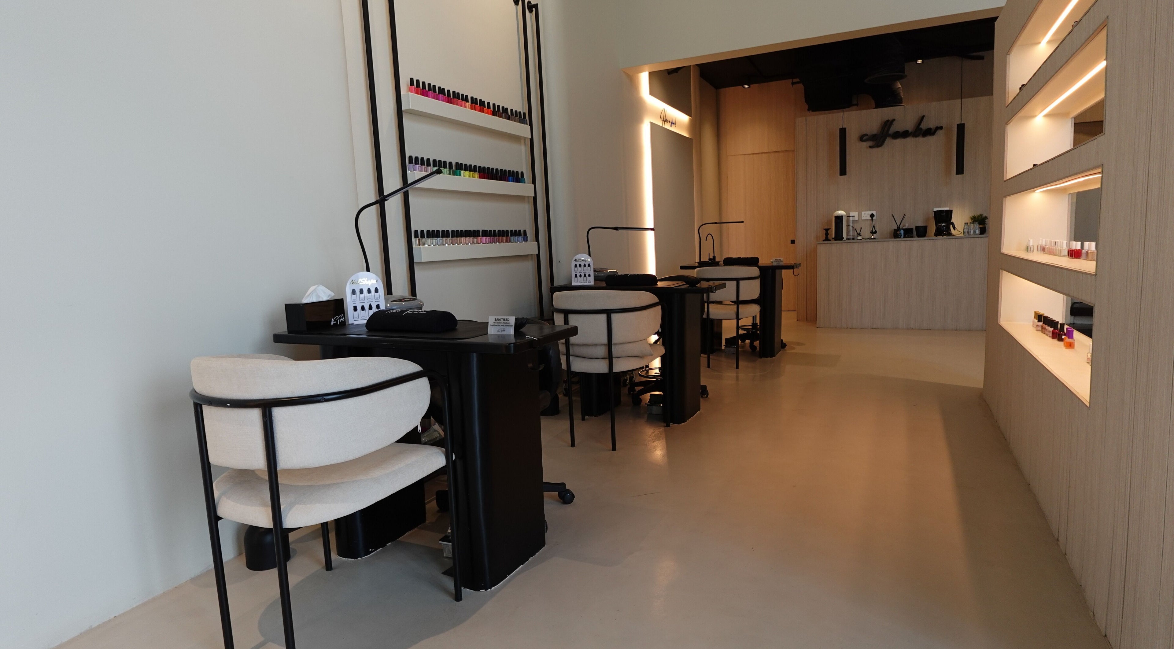Modern nail salon interior at Noura Fahed Salon, Dammam, Eastern Province, SA, featuring stylish seating.