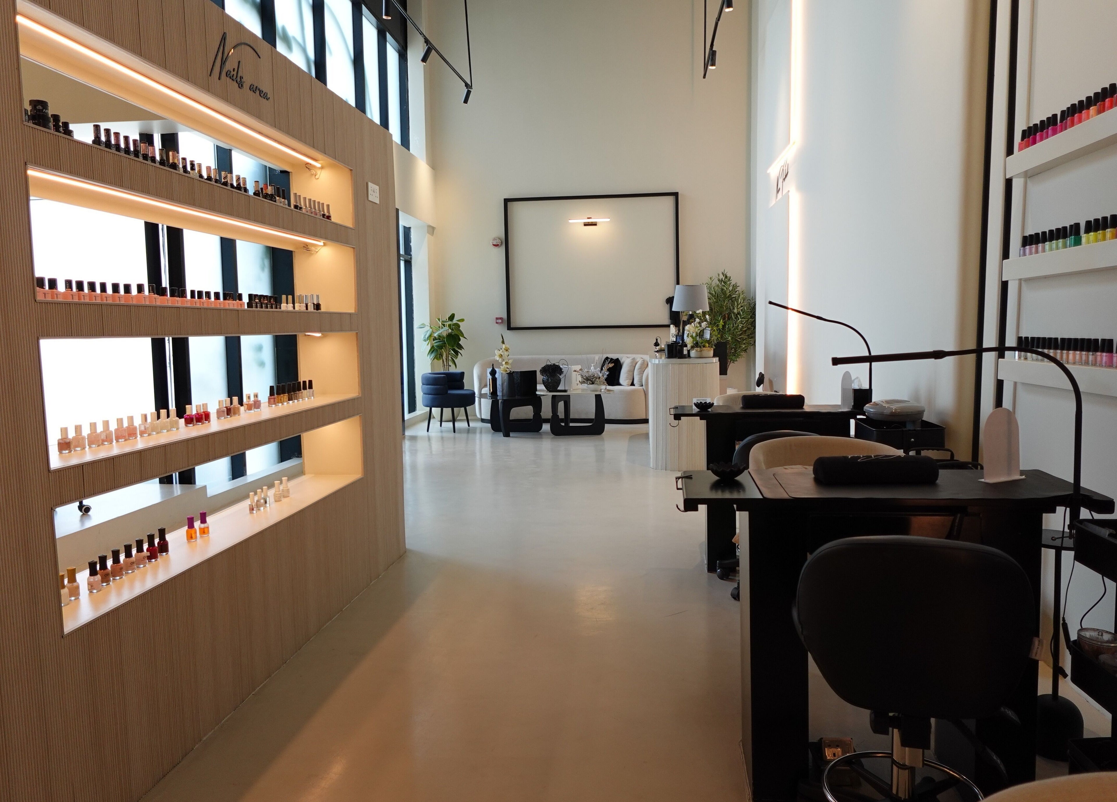 Elegant nail salon interior at Noura Fahed Salon, Dammam, Eastern Province, SA with modern decor and polish display.