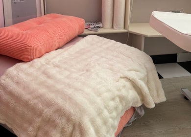 Luxurious treatment bed at Noor Beauty Lab, Enfield, England, GB, offering a relaxing wellness experience.