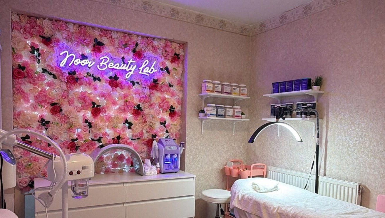 Noor Beauty Lab treatment room with floral decor in Enfield, England, GB.
