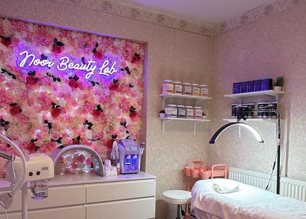 Noor Beauty Lab treatment room with floral decor in Enfield, England, GB.