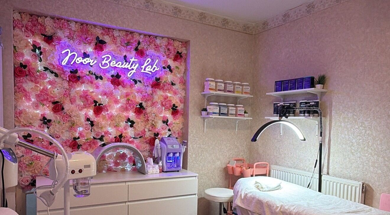Noor Beauty Lab treatment room with floral decor in Enfield, England, GB.