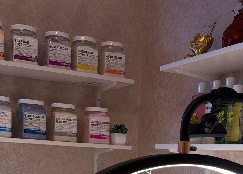 Noor Beauty Lab in Enfield, England, displays diverse skincare products on sleek white shelves.