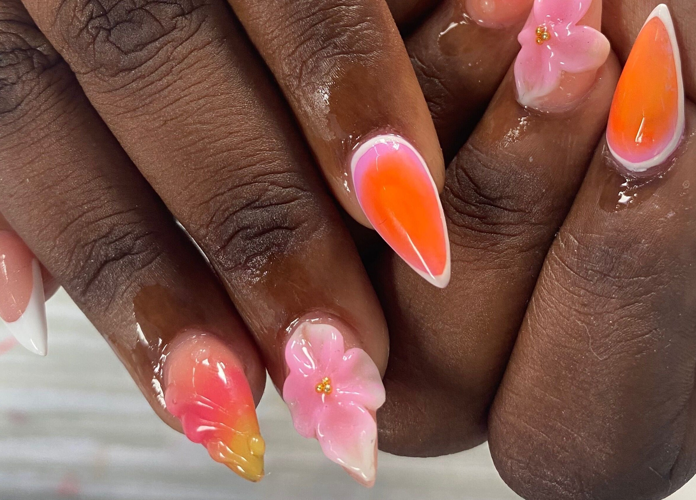 Vibrant floral nail art at NailzbyTan in Biabou, Charlotte VC, showcasing intricate designs and vivid colors.