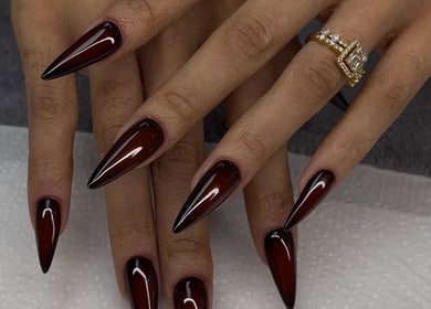 Chic, sharp dark red stiletto nails at Nelgai Beauty, Cape Town, Western Cape, ZA.