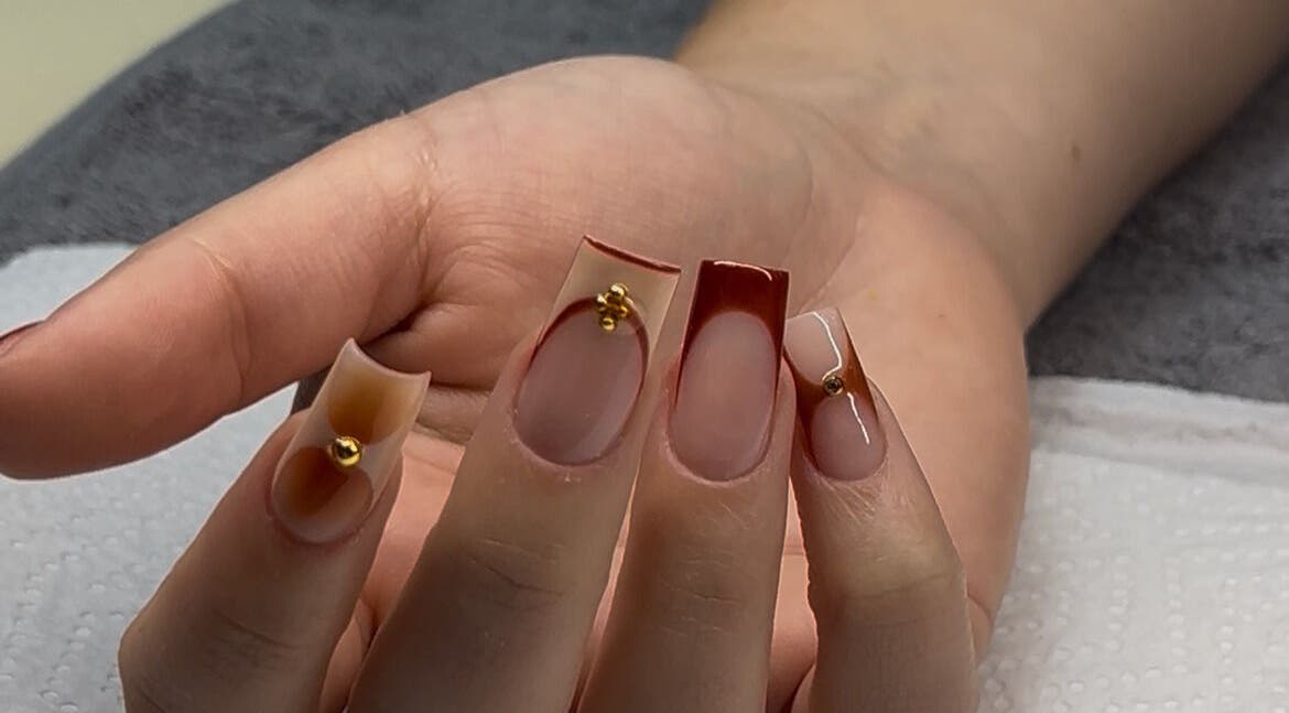 Stylish nail art with gold accents at Nelgai Beauty in Cape Town, Western Cape, ZA.