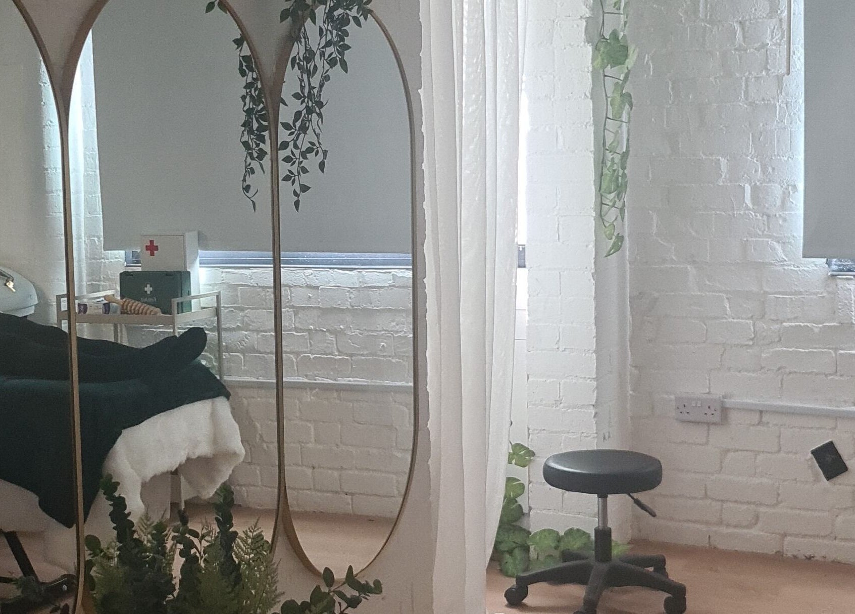Tranquil treatment room at Finesse Wellness Clinic, Leicester, England, GB, with cozy bed and elegant decor.