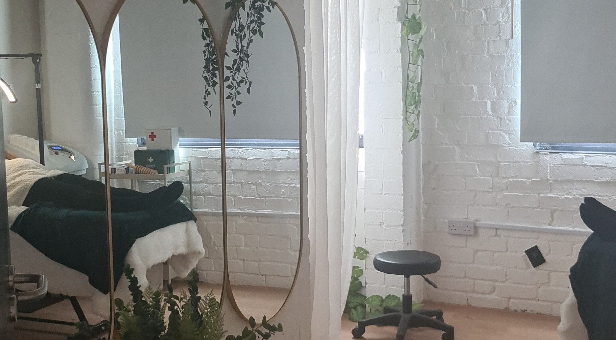 Tranquil treatment room at Finesse Wellness Clinic, Leicester, England, GB, with cozy bed and elegant decor.