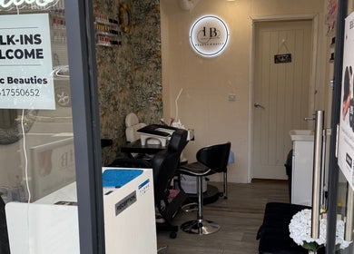 Interior of Iconic Beauties salon, Hayes, England with chic decor and welcoming seating.