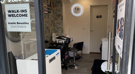 Interior of Iconic Beauties salon, Hayes, England with chic decor and welcoming seating.