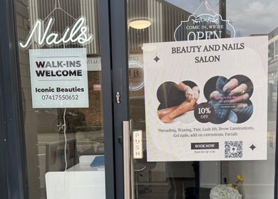 Entrance to Iconic Beauties salon in Hayes, England with signs for walk-ins and beauty services.