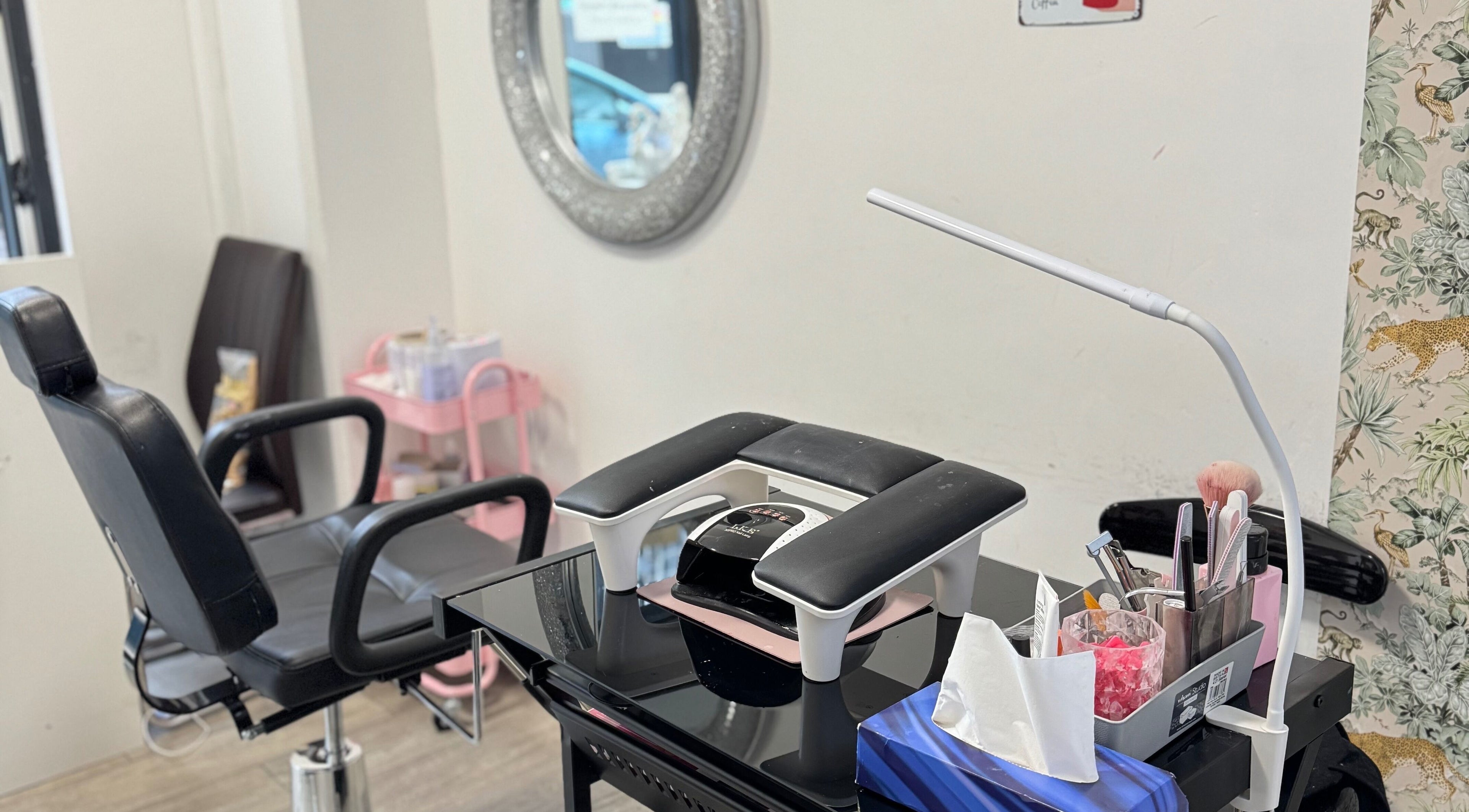 Nail station at Iconic Beauties, Hayes, England, GB, showcasing tools and comfortable seating.