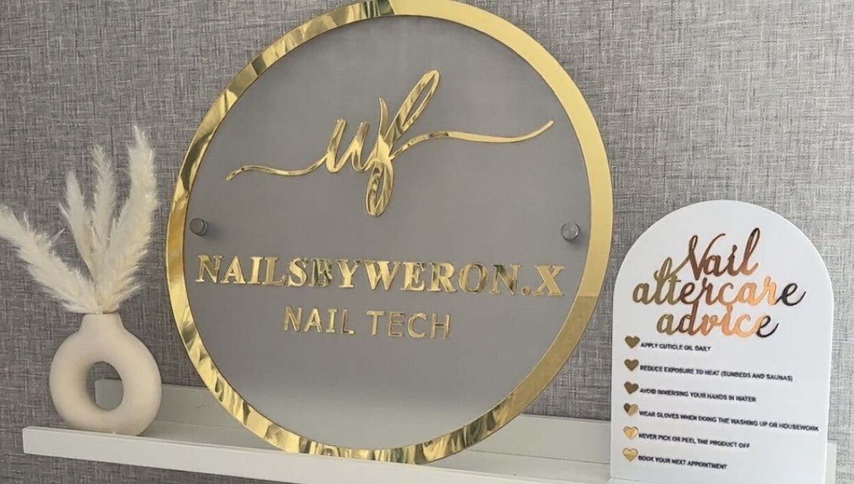 Elegant sign with gold accents at Nails By Weron, Halifax, England, GB, showcasing nail tech services.