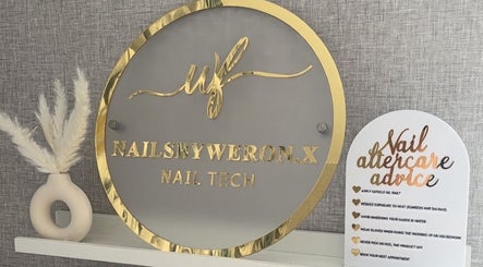 Elegant sign with gold accents at Nails By Weron, Halifax, England, GB, showcasing nail tech services.