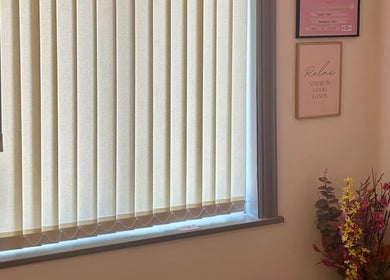 A calming window view with floral decor at Flourishskinroom in Coventry, England, GB.