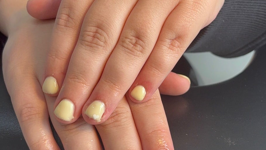 Close-up of pastel yellow manicured nails at beautybar_.byterri in Hebburn, England, GB.