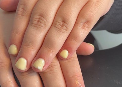 Close-up of pastel yellow manicured nails at beautybar_.byterri in Hebburn, England, GB.