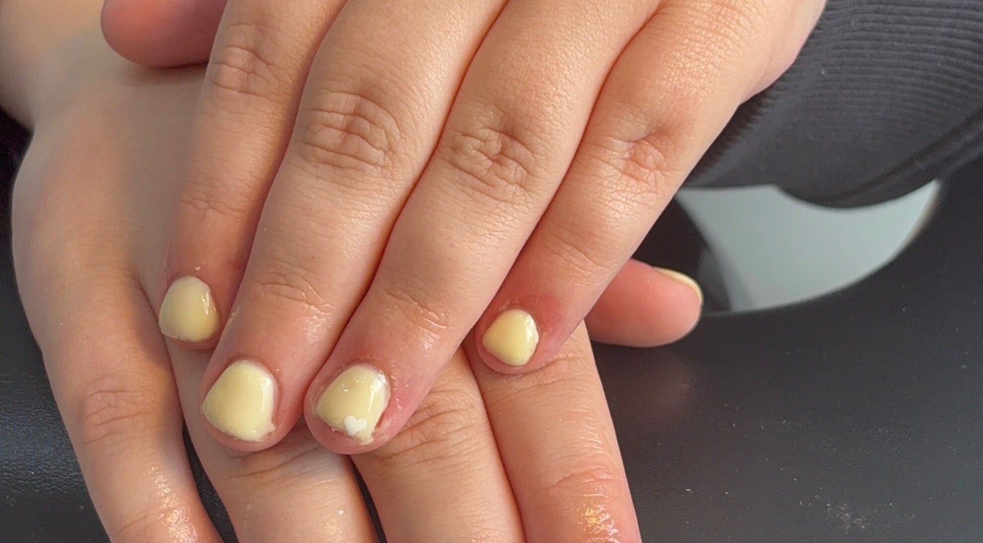 Close-up of pastel yellow manicured nails at beautybar_.byterri in Hebburn, England, GB.