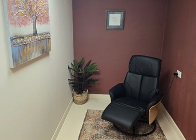 Relaxation chair at Oxygen Cove Cork, Cork, County Cork, IE. Tranquil corner with a plant and artwork.