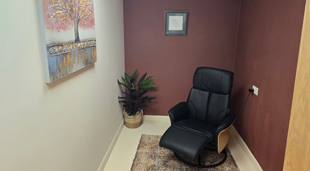 Relaxation chair at Oxygen Cove Cork, Cork, County Cork, IE. Tranquil corner with a plant and artwork.