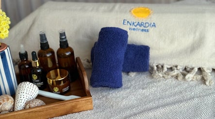 Spa essentials at Enkardia Wellness, Γλυφάδα, GR. Includes oils, towels, and shells for a relaxing experience.