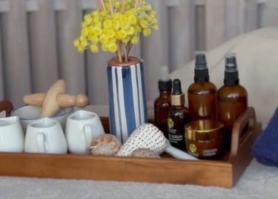 Elegant wellness tray with oils and flowers at Enkardia Wellness, Γλυφάδα, GR, enhancing a soothing ambiance.