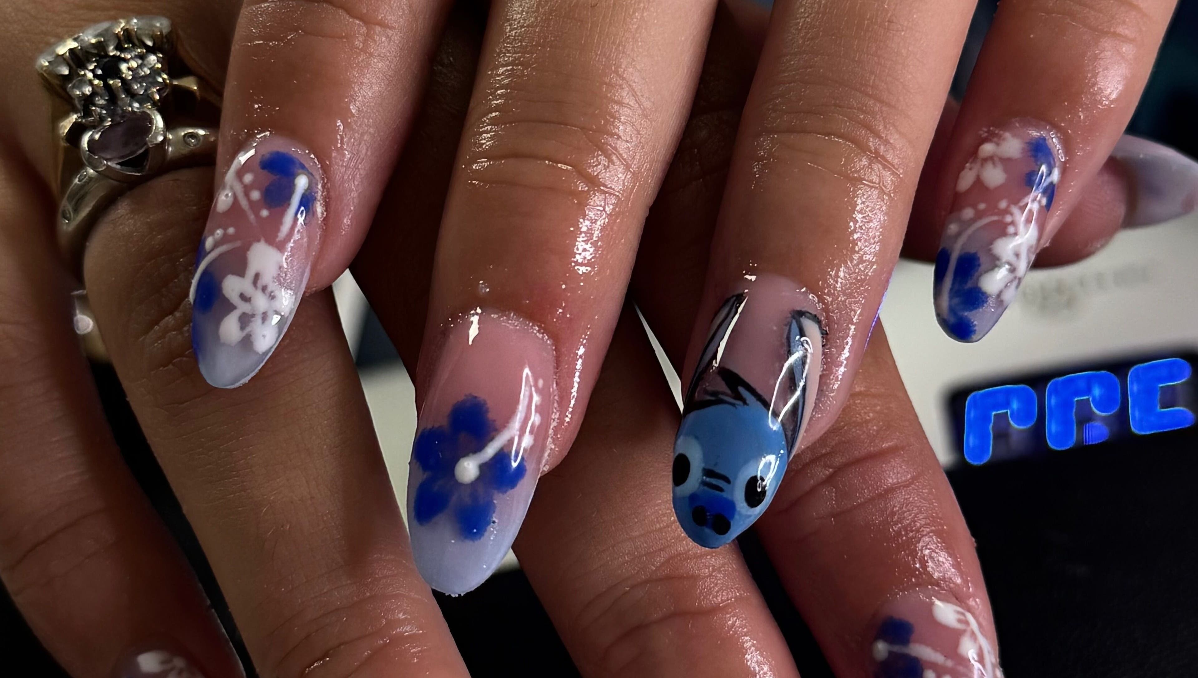 Elegant blue floral nail art at BeauteDeLuxeByMia, Selsey, England, GB.