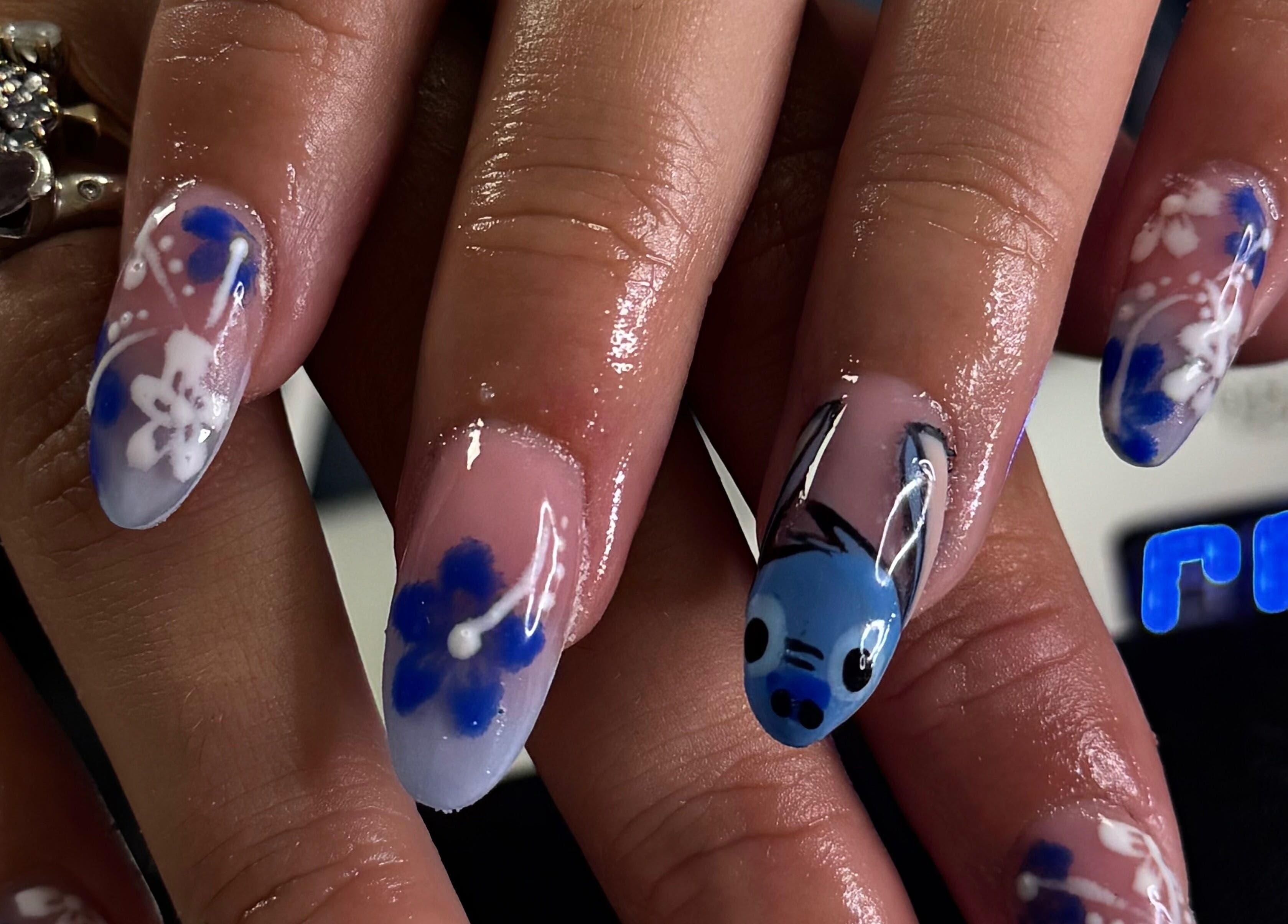 Elegant blue floral nail art at BeauteDeLuxeByMia, Selsey, England, GB.