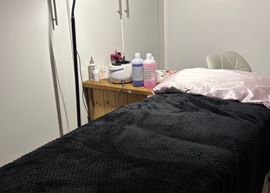 Cozy treatment room with a black-covered bed at Beauty By Molly, Leek, England, GB.