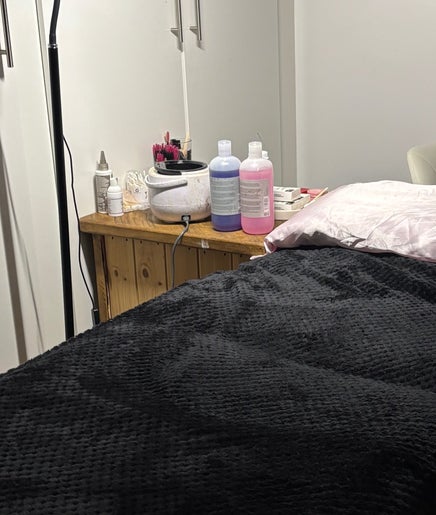 Cozy treatment room with a black-covered bed at Beauty By Molly, Leek, England, GB.